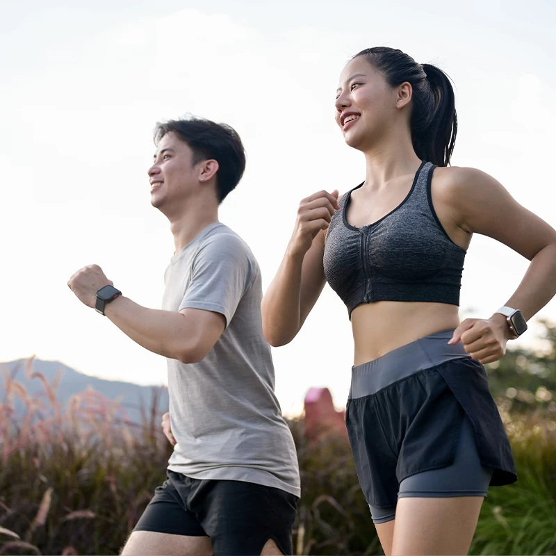 An active sportswear couple running in the park in the morning