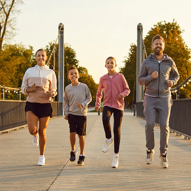 Happy sporty active family in sportswear running together outdoor