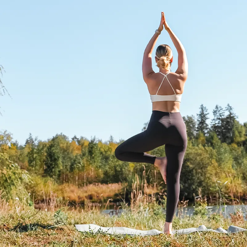 Model wearing sustainable sportswear exercise in nature