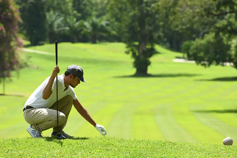 Young man in golf pants playing golf