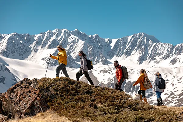young dressed in outdoor sportswear hiking up the mountain
