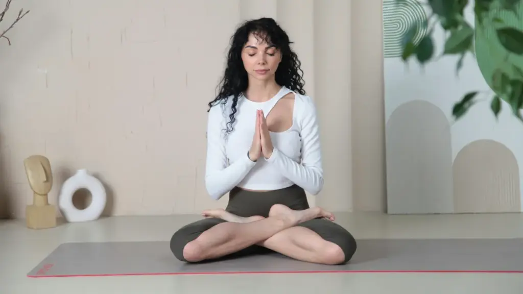 woman in yogawear sitting on the floor